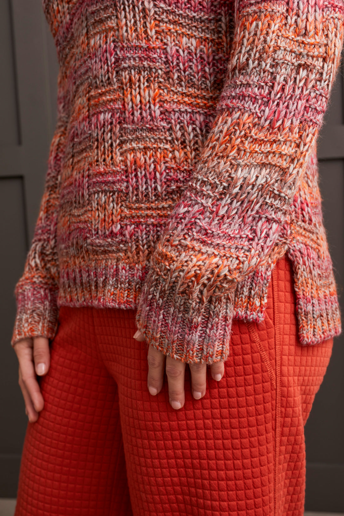 A person wearing a multicolored, fashionable long sleeve cowl neck sweater by Tribal with a textured pattern.