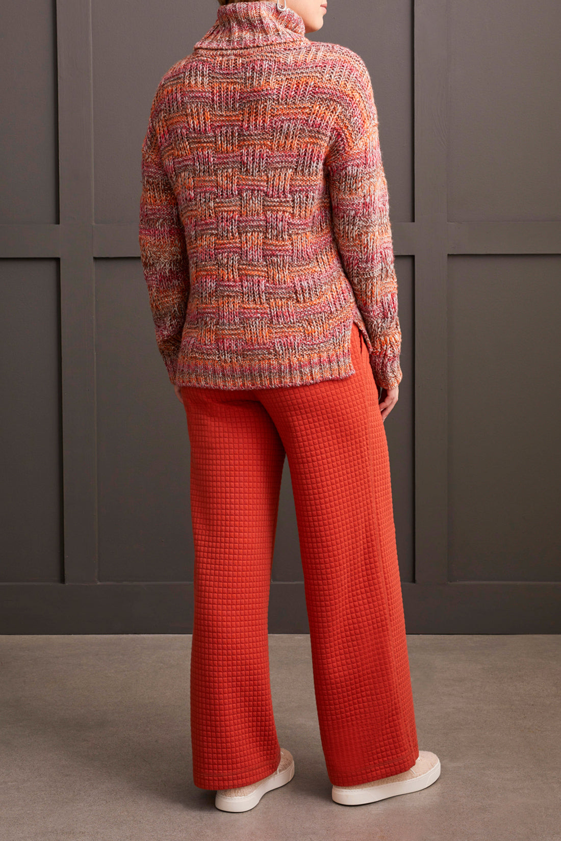 A person wearing a multicolored, fashionable long sleeve cowl neck sweater by Tribal with a textured pattern.