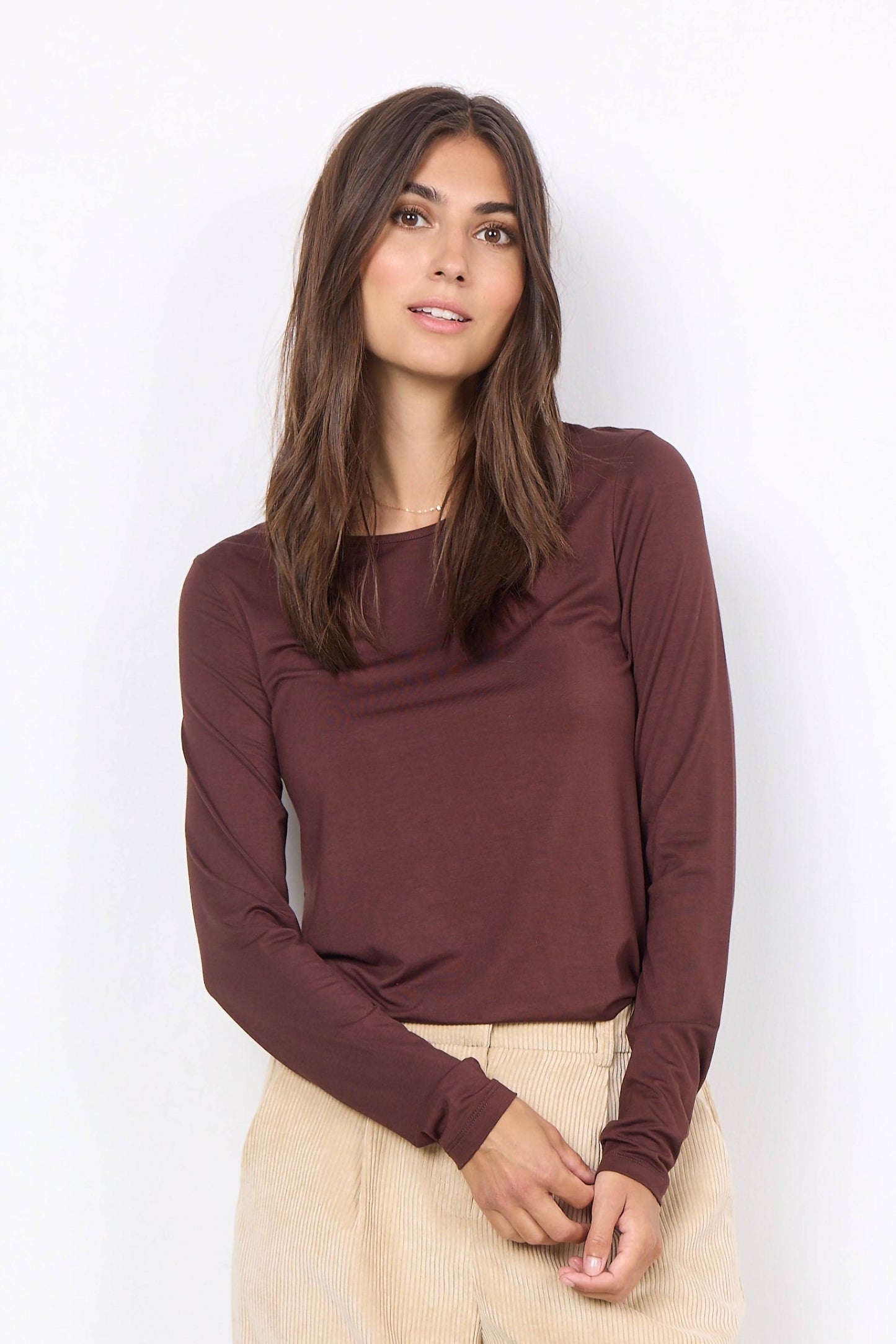 The model is wearing a soft quality Marcia 217 Rounded Neck Blouse with a checkered skirt. (Brand Name: Soya Concepts)