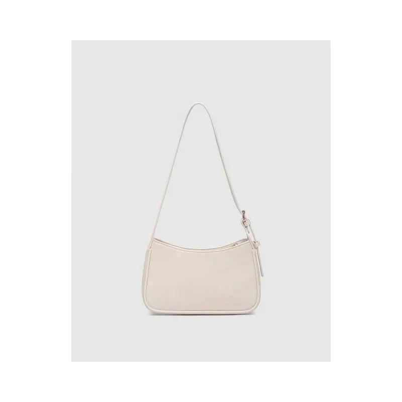 The Louenhide Ivy Shoulder Bag in Vanilla is a small, rectangular, off-white minimalist handbag with a single strap, shown against a plain light gray background.