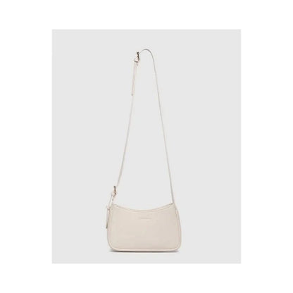 The Louenhide Ivy Shoulder Bag in Vanilla is a small, rectangular, off-white minimalist handbag with a single strap, shown against a plain light gray background.