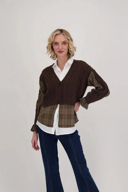 Showcasing a versatile layered look against a plain background, a person is wearing the Shirt With Cable Knit Cardigan Topper by Gabby Isabella over a white shirt and blue jeans.
