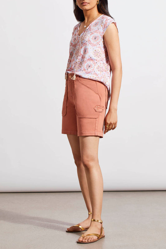 A woman in Dark Cyder Patch Pocket Girlfriend Shorts by Tribal is standing in front of a white wall.