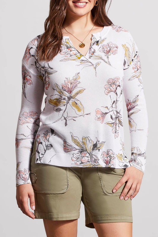 Woman wearing a Tribal long sleeve split V neck sweater and olive green shorts.