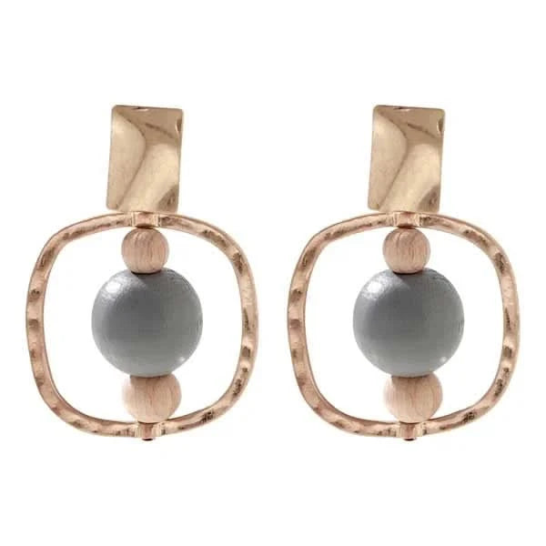 The Merx Natural Stone Wood Earrings feature gold-tone frames, wooden beads, and large gray stone centers—an elegant mixed-material accessory.