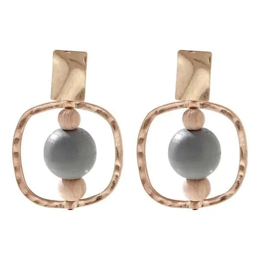 The Merx Natural Stone Wood Earrings feature gold-tone frames, wooden beads, and large gray stone centers—an elegant mixed-material accessory.