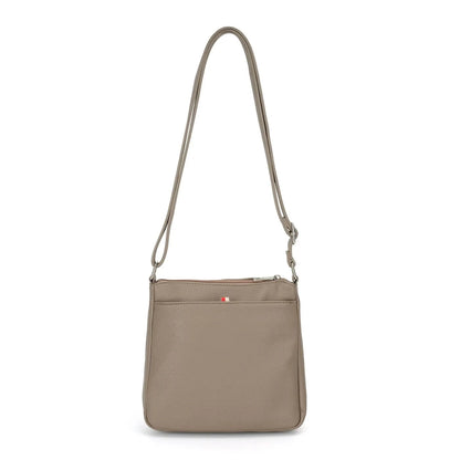 The Stelle organizer crossbody by Co-Lab features taupe vegan leather, a long adjustable strap, front flap pocket, and silver hardware, shown on a plain white background.