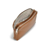 Co-Lab’s THE 'ALTHI' DOUBLET CROSSBODY is a brown vegan leather bag with silver hardware and an adjustable strap, shown against a white background—an essential accessory for effortless everyday style.