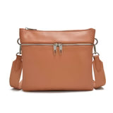 Co-Lab THE 'ARQUETTE' CROSSBODY: tan vegan leather bag with silver hardware, front zipper pocket, and adjustable strap, shown on a white background.