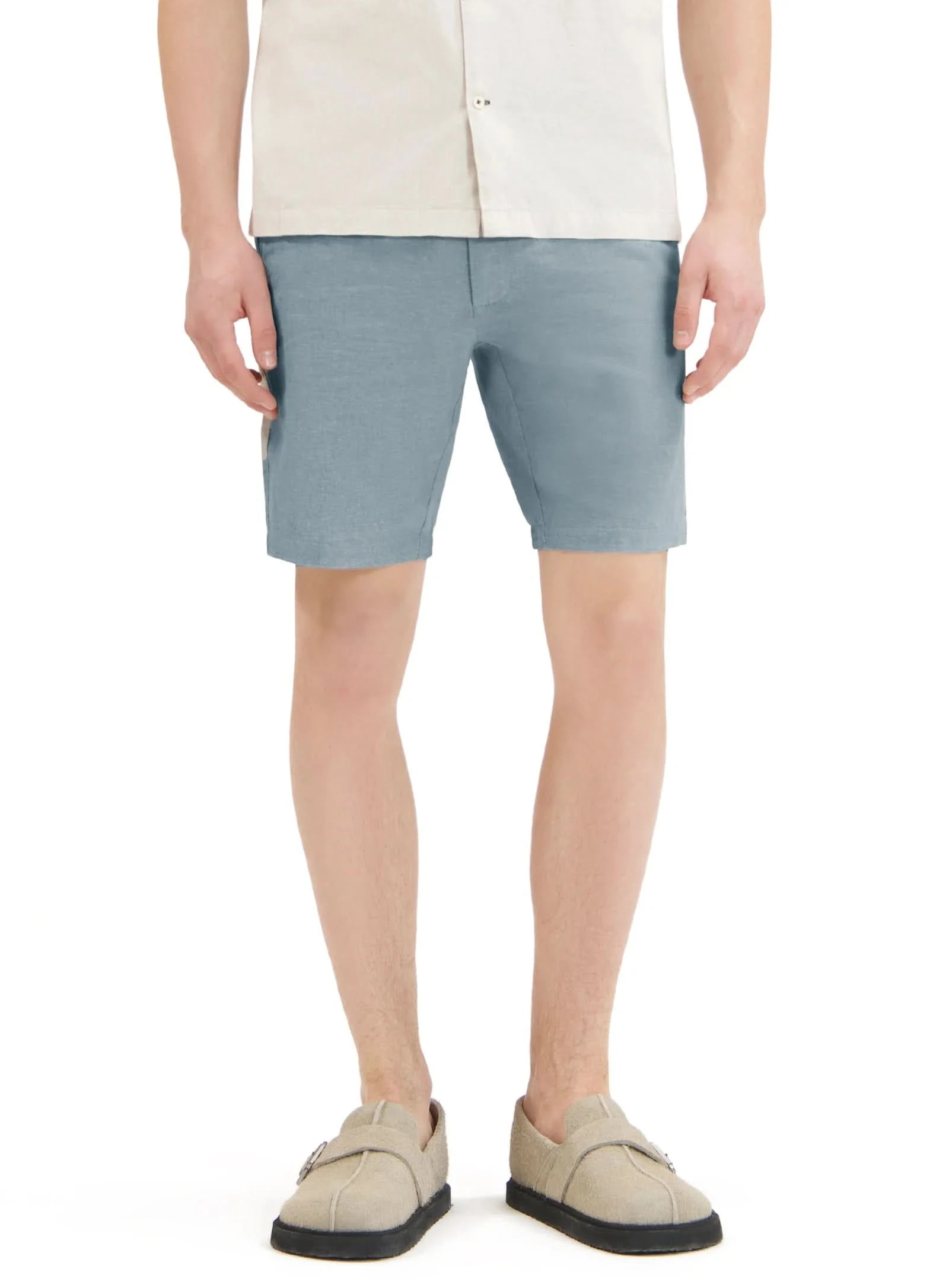 Close-up of a person wearing Point Zero Mens Chino Linen Flat Front Shorts in blue and a white textured shirt, with their right hand by their side—showcasing an effortless summer look in breathable fabric.