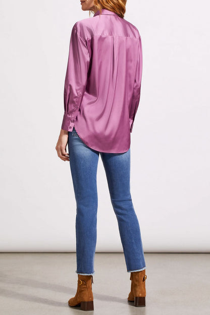 A person dressed in a cozy fall top, specifically the beige Drop Shoulder Shirt by Tribal with silk fabric, pairs it effortlessly with dark jeans against a light background.