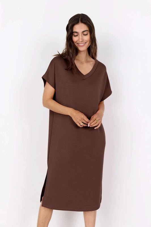 A woman stands against a white background wearing the Soya Concepts Banu V Neck Dress—a loose-fitting, knee-length pink dress with short sleeves.
