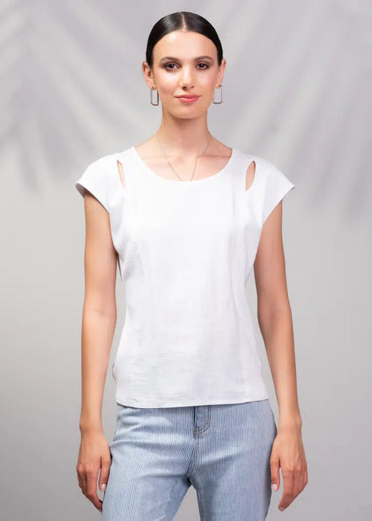 Someone in Alison Sheri's light green Cap Sleeve Linen Rib Top and breezy white pants poses against a blurred background.