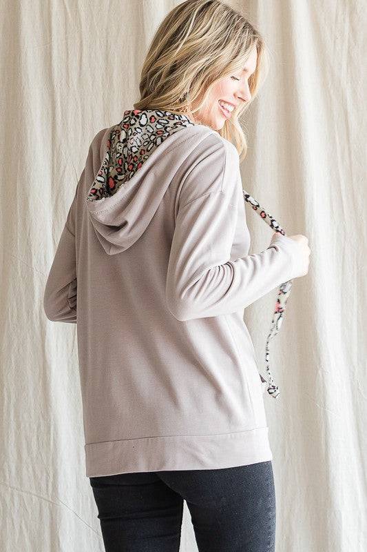A woman wearing a Vanilla Monkey Animal Print Hoodie.