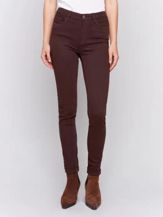 A person wearing Charlie B's brown Cuffed Hem Twill Jeans, a white top, and brown ankle boots stands against a plain background, showcasing the slimming effect and quality materials of the outfit.