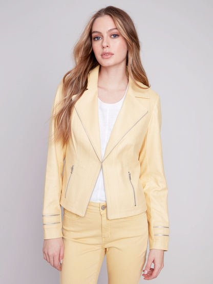 A woman wearing a yellow Charlie B Vintage Moto Faux Leather Jacket.
