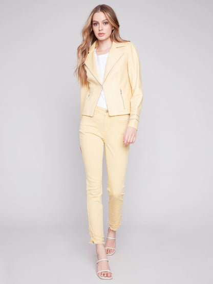 A woman wearing a yellow Charlie B Vintage Moto Faux Leather Jacket.