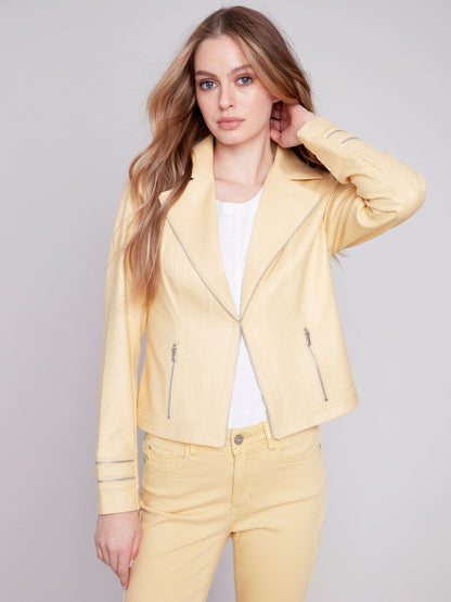 A woman wearing a yellow Charlie B Vintage Moto Faux Leather Jacket.