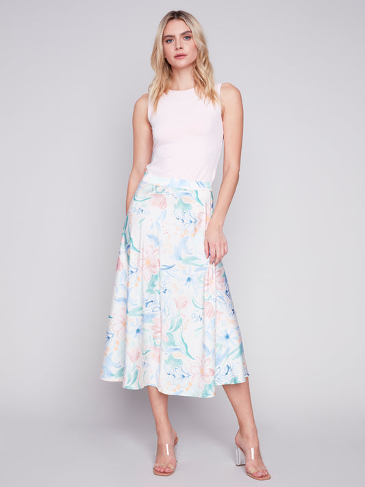 Woman posing in a sleeveless top and Charlie B Petal Flow Long Satin Skirt.