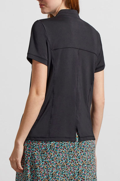 A woman wearing a comfortable fit Tribal blue and white polka dot skort.
