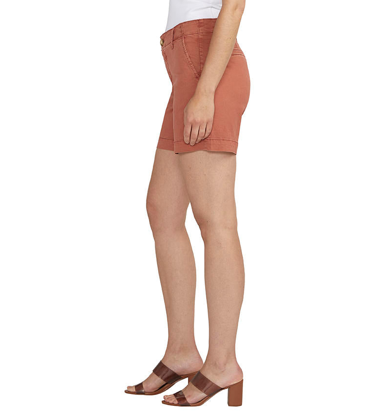 Woman wearing Jag Chino Mid Rise Shorts in beige and white open-toe sandals stands against a plain background.