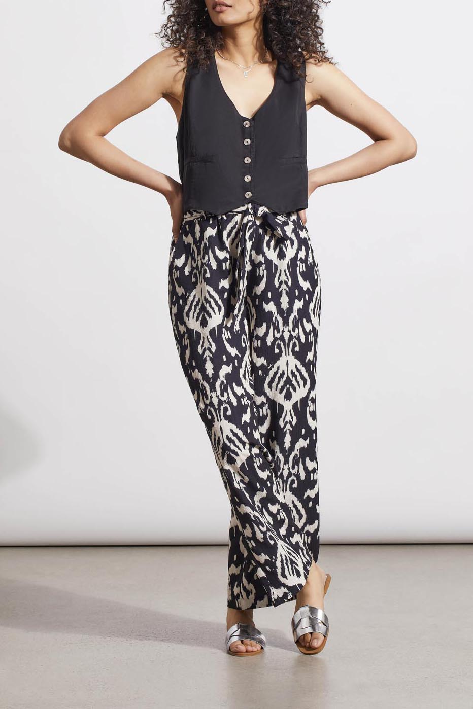 Woman posing in a black sleeveless top and Tribal Printed Pull on Belted Pants with hands on hips.