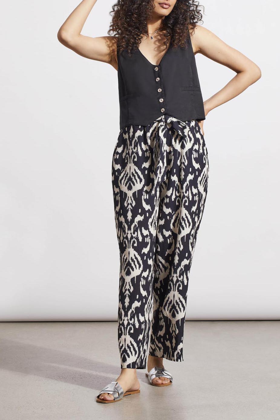 Woman posing in a black sleeveless top and Tribal Printed Pull on Belted Pants with hands on hips.
