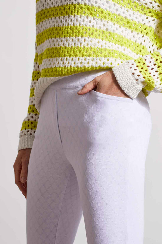 A woman wearing white Tribal Pull On Capri with rounded slits on the bottom.