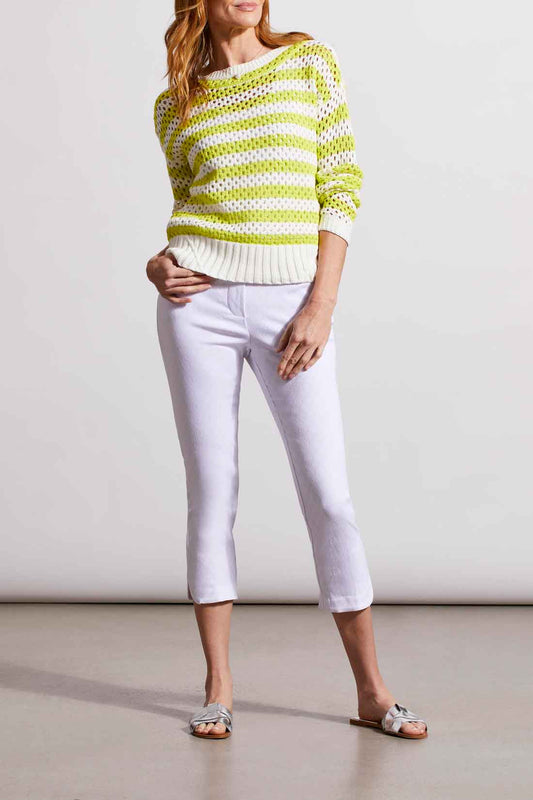 A woman wearing white Tribal Pull On Capri with rounded slits on the bottom.