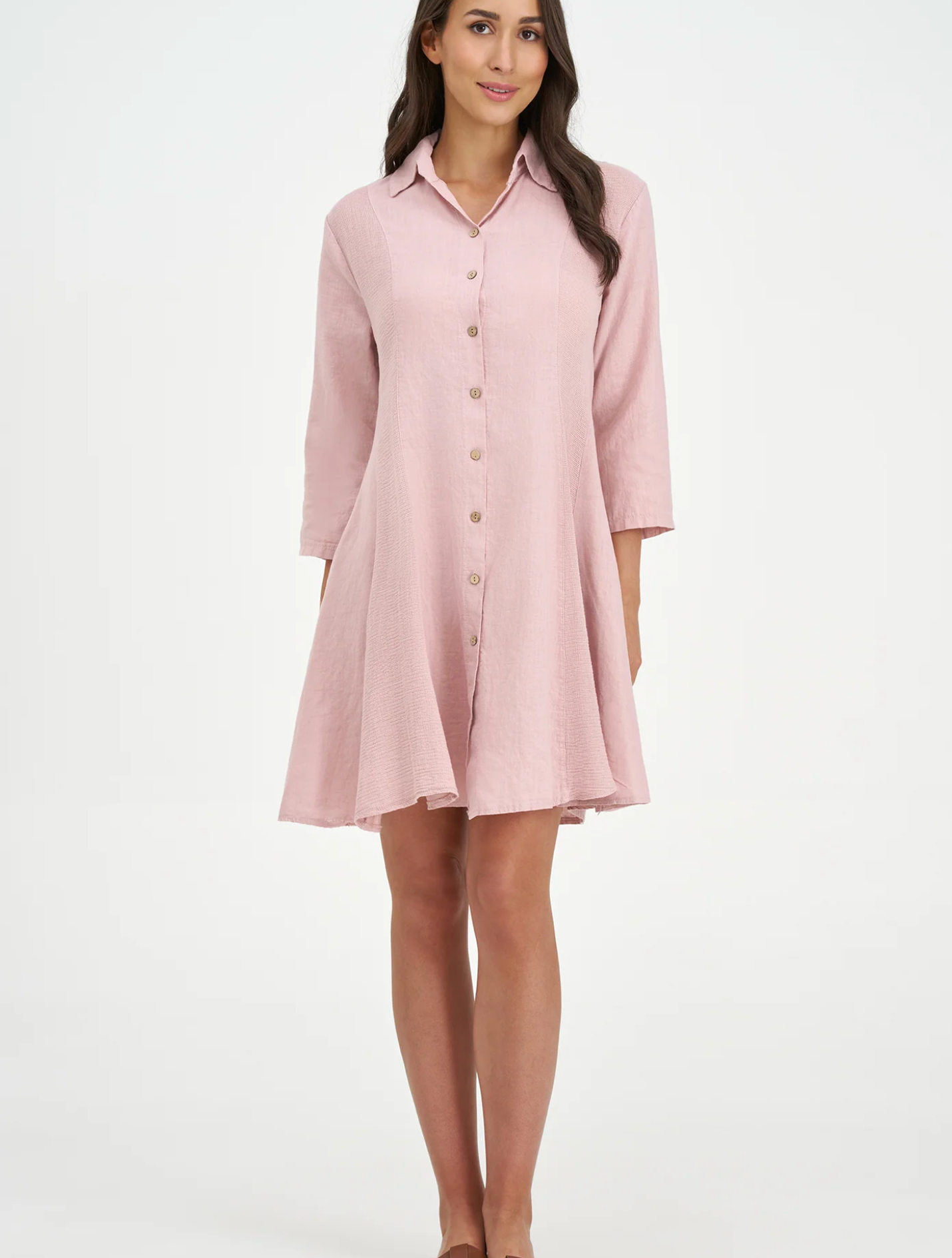 A woman models the M Made In Italy "Made in Italy Dress," a light pink, collared linen dress with three-quarter sleeves—perfect for elevating your spring wardrobe.