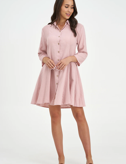A woman models the M Made In Italy "Made in Italy Dress," a light pink, collared linen dress with three-quarter sleeves—perfect for elevating your spring wardrobe.