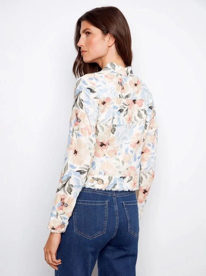 A woman models the Charlie B Printed Linen Blend Jacket over a white top and blue jeans against a plain white backdrop—a stylish spring essential.