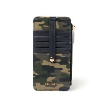 A woman sitting on a bench with a blue Kedzie Slim Zippered Wallet that has card slots.
