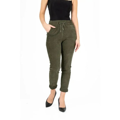 An individual dressed in a black strapless top, M Made In Italy's Olive Branch Woven Pant featuring pockets, and black pointed shoes stands against a white background, exemplifying a comfortable style.