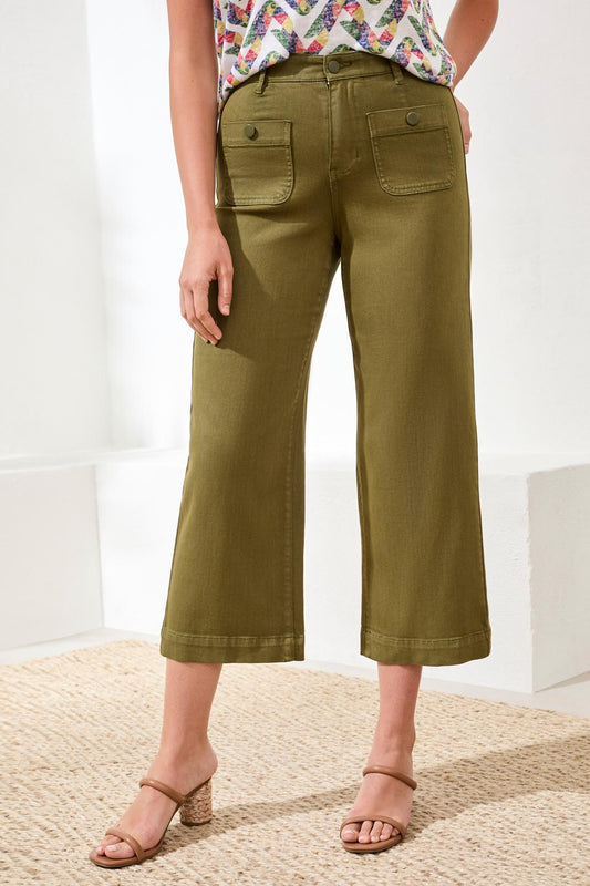 A woman stands indoors wearing a patterned short-sleeve top, Tribal Sophia Crop Palazzo Pant with a flattering fit and front pockets, paired with beige heeled sandals.