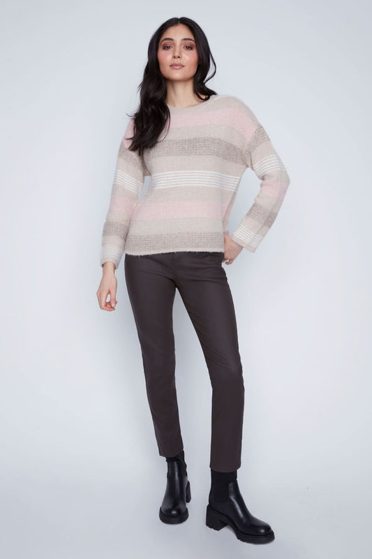 A woman stands against a plain background wearing the CoCo Y Club Stripped Knitted Sweater, paired with dark pants and black ankle boots.
