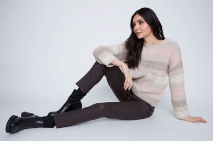 A woman stands against a plain background wearing the CoCo Y Club Stripped Knitted Sweater, paired with dark pants and black ankle boots.