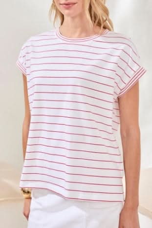 A woman wears the Tribal CAP SLEEVE TOP—white cotton-spandex with thin red stripes—paired with white bottoms. Soft, neutral lighting highlights this wardrobe basic’s versatility.