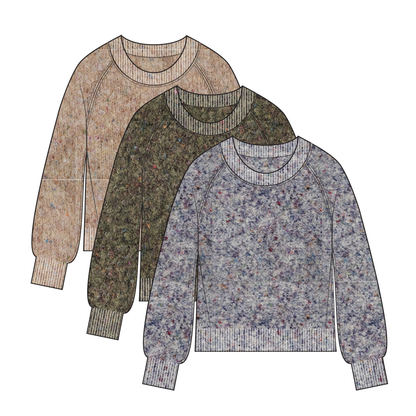 A woman wears brown pants and a Tribal Knit Crewneck Sweater Ivy.