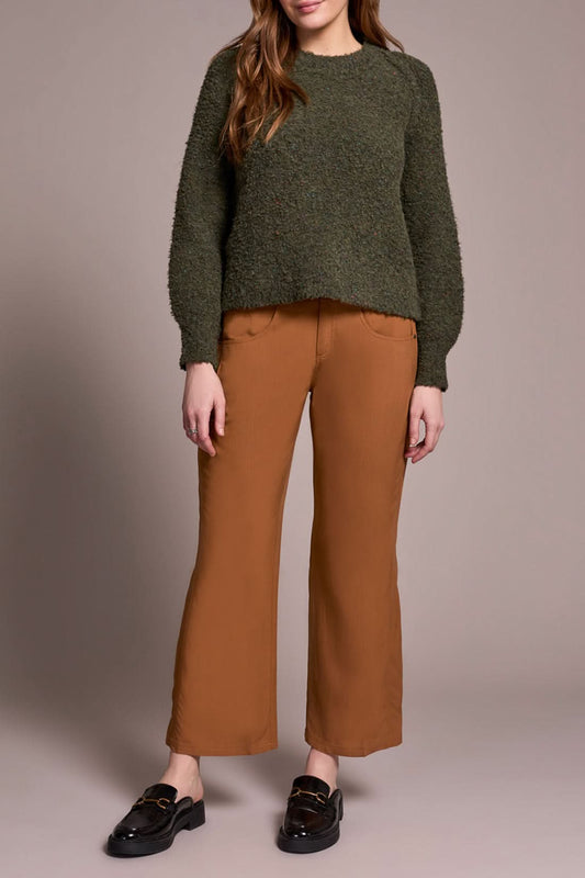 A woman wears brown pants and a Tribal Knit Crewneck Sweater Ivy.