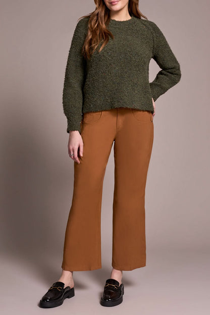 A woman wears brown pants and a Tribal Knit Crewneck Sweater Ivy.