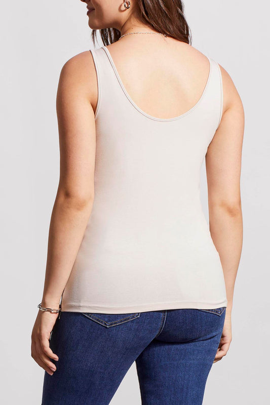 A woman in a cream Tribal Two Way Camisole and blue jeans, standing with one hand partially in her pocket.