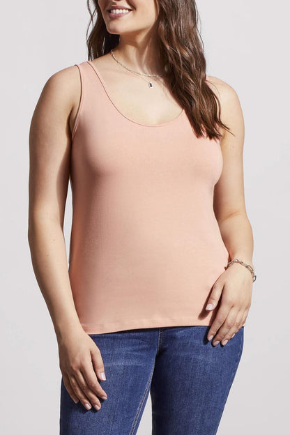 A woman in a cream Tribal Two Way Camisole and blue jeans, standing with one hand partially in her pocket.
