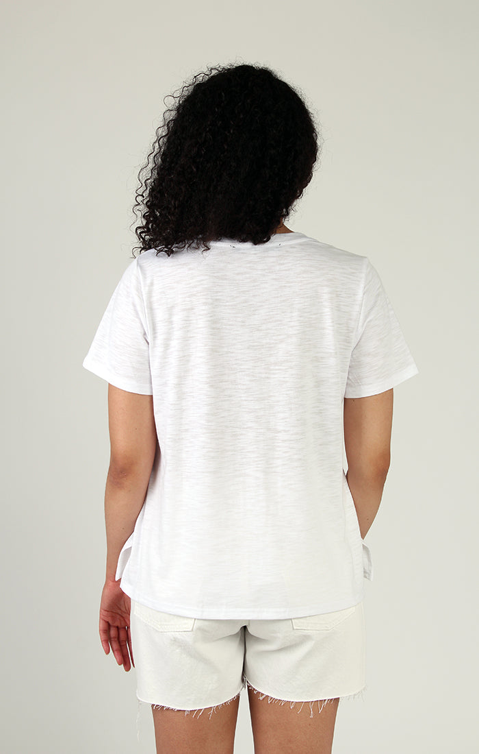 Woman wearing a stylish Fresh FX short sleeve leaf print cotton tee smiling at the camera.