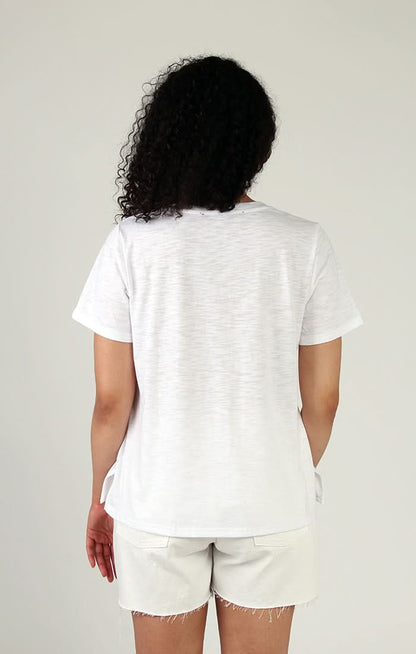 Woman wearing a stylish Fresh FX short sleeve leaf print cotton tee smiling at the camera.