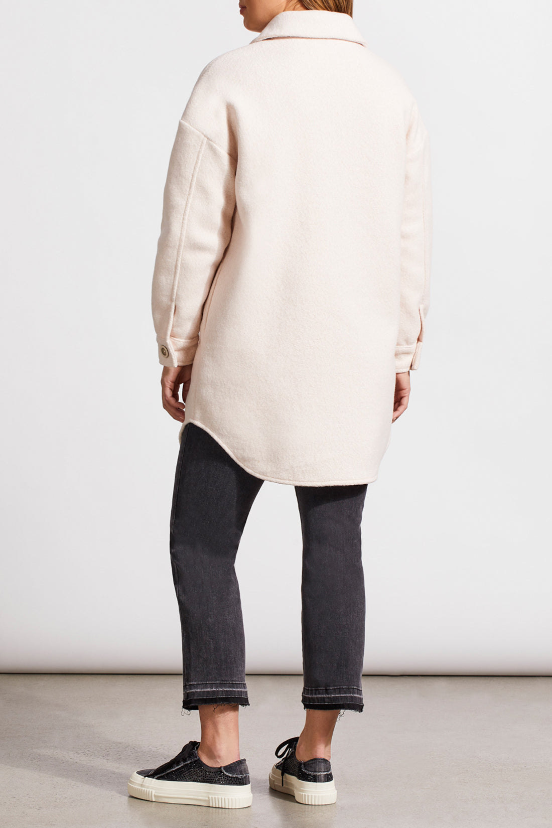 An individual with light hair is wearing a pale cream Stretch Boiled Wool Jacket by Tribal, featuring double-breasted button details. They are also dressed in a ribbed turtleneck sweater and are positioned against a plain background.
