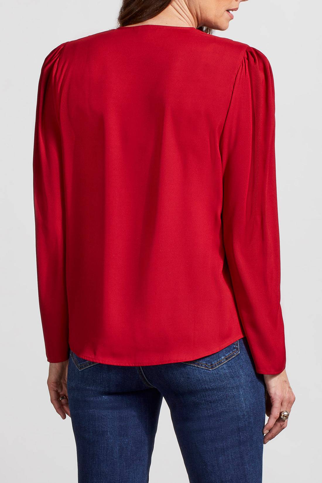 A woman wearing a comfortable Tribal Pleated Wrap Blouse.