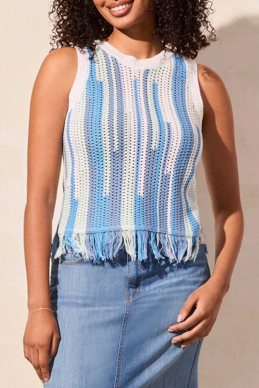 A person faces away, wearing the Tribal CREW NECK FRINGED HEM SWEATER with blue and white stripes, paired with a long light blue denim skirt and beige shoes.