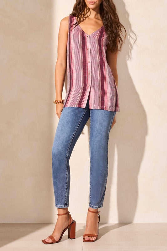 A woman wears the Tribal LINEN BLEND STRIPED BUTTON-DOWN CAMI with red and pink stripes, styled with blue jeans, creating a look that's both casual and sophisticated against a light background.