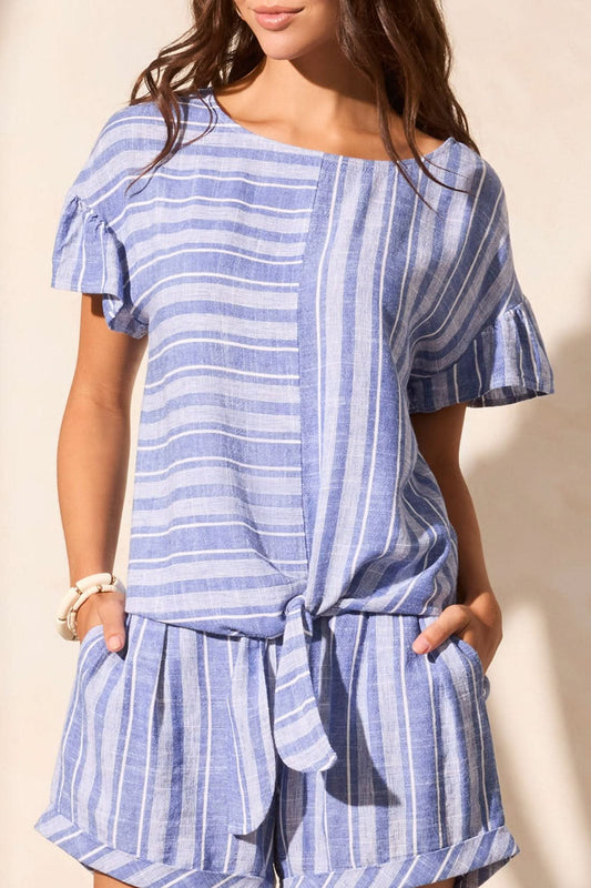 A woman wearing the Tribal Tie-Front Blouse with Frilled Sleeve and matching blue and white striped shorts, perfect for summer, stands against a neutral background.